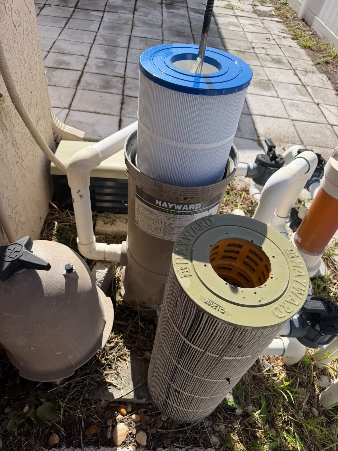 Pool filter cartridge being cleaned